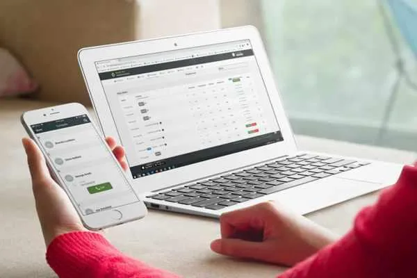 AXIS HR & Payroll used on a laptop and a mobile phone